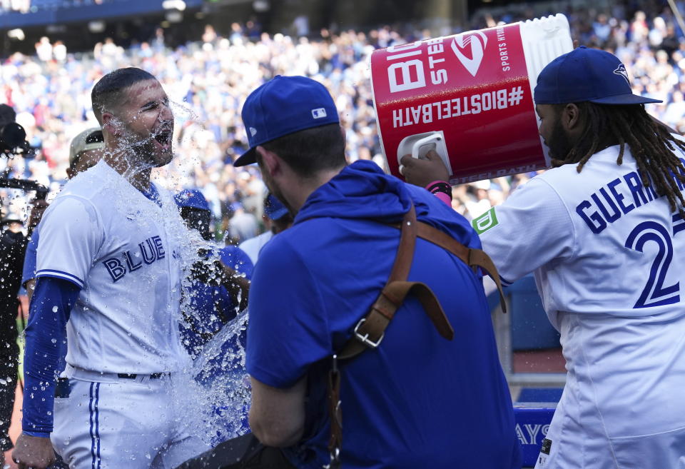 Toronto Blue Jays center fielder Kevin Kiermaier gets water dumped on him after defeating the Kansas City Royals during a baseball game in Toronto on Sunday, Sept. 10, 2023. (Nathan Denette/The Canadian Press via AP)