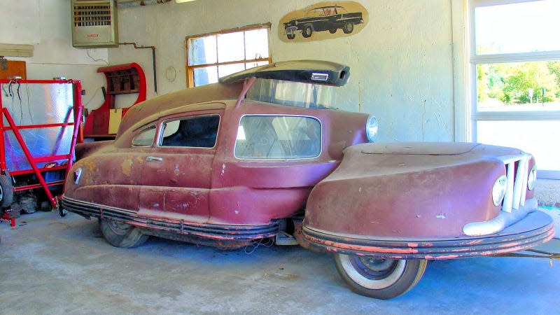 A photo of a rusty Sir Vival concept car in a garage. 