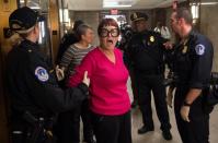 <p>U.S. Capitol Police arrest a protester demonstrating against tax reform outside a Senate Budget Committee hearing on Capitol Hill in Washington, Nov. 28, 2017. (Photo: Saul Loeb/AFP/Getty Images) </p>