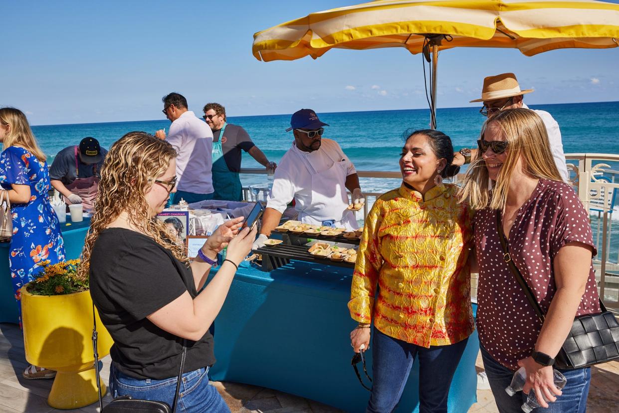 Celebrity chef Maneet Chauhan poses for a seaside photo during a cookout event at the 2022 Palm Beach Food & Wine Festival.