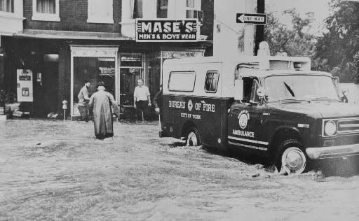 A City of York Bureau of Fire ambulance works on a flooded street during Tropical Storm Agnes. The flooding cost the city $10 million. More than 2,200 city buildings were damaged, and 111 families were displaced, the York Daily Record reported at the time.