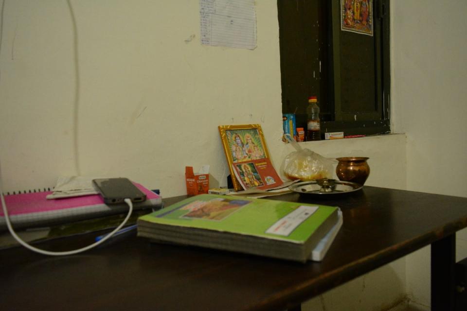 Picture of Hindu gods and goddesses placed on study table in a hostel room in Kota (Namita Singh/The Independent)