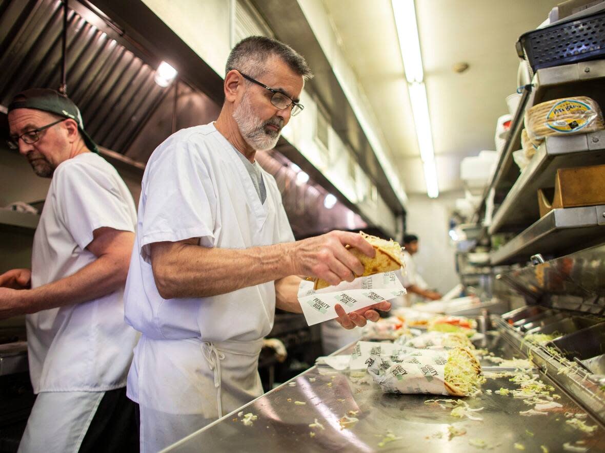 Van Niforos, owner of Windsor's Penalty Box restaurant prepares food in his kitchen Windsor, Ont., on Tuesday, June 12, 2018. On Monday, Windsor city council approved new measures to help businesses amid the pandemic.  (Geoff Robins/Canadian Press - image credit)