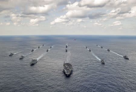 U.S. Navy and Japan Maritime Self-Defense Force ships steam in formation during their military manoeuvre exercise known as Keen Sword 15 in the sea south of Japan, in this November 19, 2014 handout provided by the U.S. Navy. REUTERS/Mass Communication Specialist 3rd Class Chris Cavagnaro/U.S. Navy/Handout via Reuters