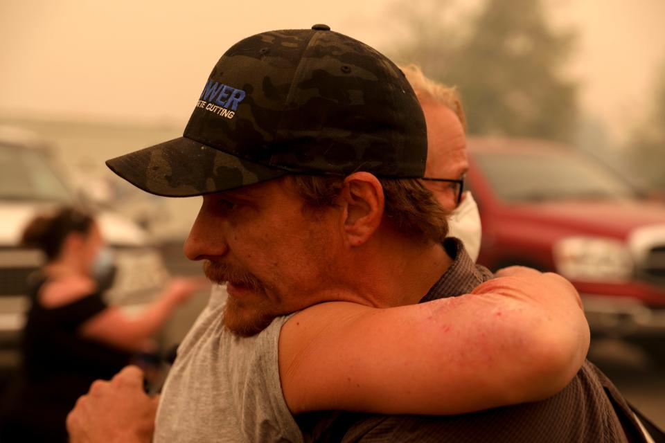 Chris Tofte hugs a friend before a group leaves to search for his son Wyatt Tofte, 13, and his dog Duke in Stayton, Oregon on Wednesday, Sept. 9, 2020.