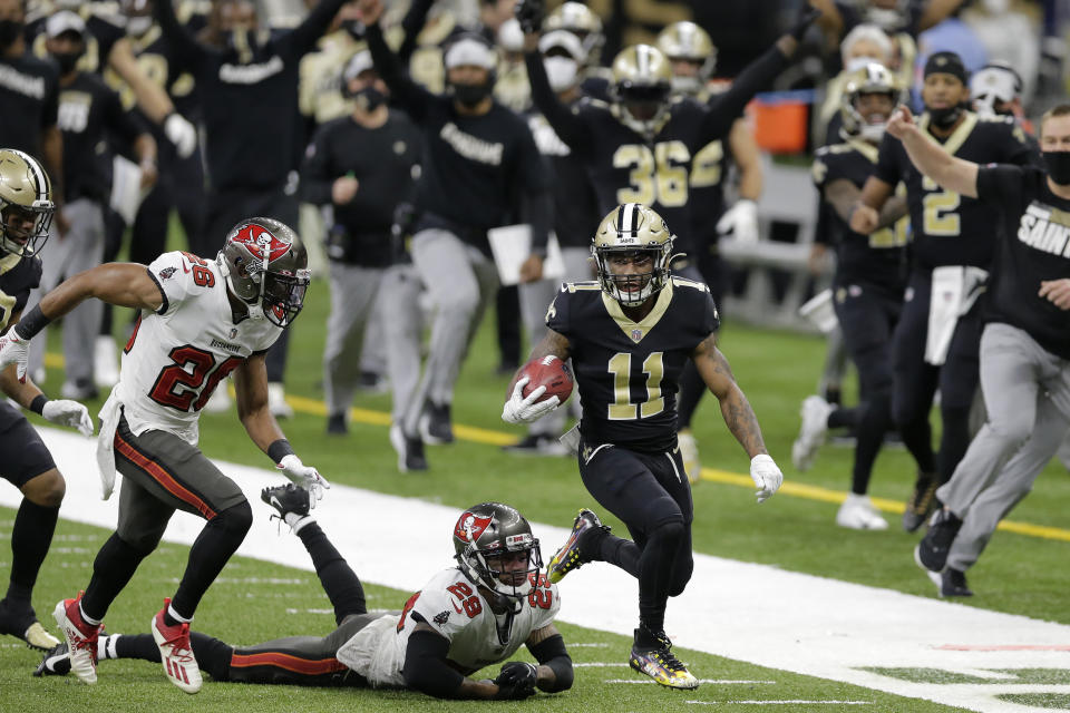 New Orleans Saints' Deonte Harris (11) returns a punt against the Tampa Bay Buccaneers during the first half of an NFL divisional round playoff football game, Sunday, Jan. 17, 2021, in New Orleans. (AP Photo/Brett Duke)