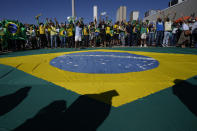 Supporters of Brazil's President Jair Bolsonaro shout during a pro-Bolsonaro rally at the Esplanade of Ministries, in Brasilia, Brazil, Sunday, Aug. 1, 2021. Political backers of President Bolsonaro have called for nationwide rallies to express their support for the embattled leader and his call for adding printouts to the electronic voting system. (AP Photo/Eraldo Peres)