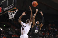 Oregon State's Ahmad Rand (44) and Washington's Langston Wilson (13) vie for possession of a rebound during the first half of an NCAA college basketball game Thursday, Jan. 20, 2022, in Corvallis, Ore. (AP Photo/Amanda Loman)