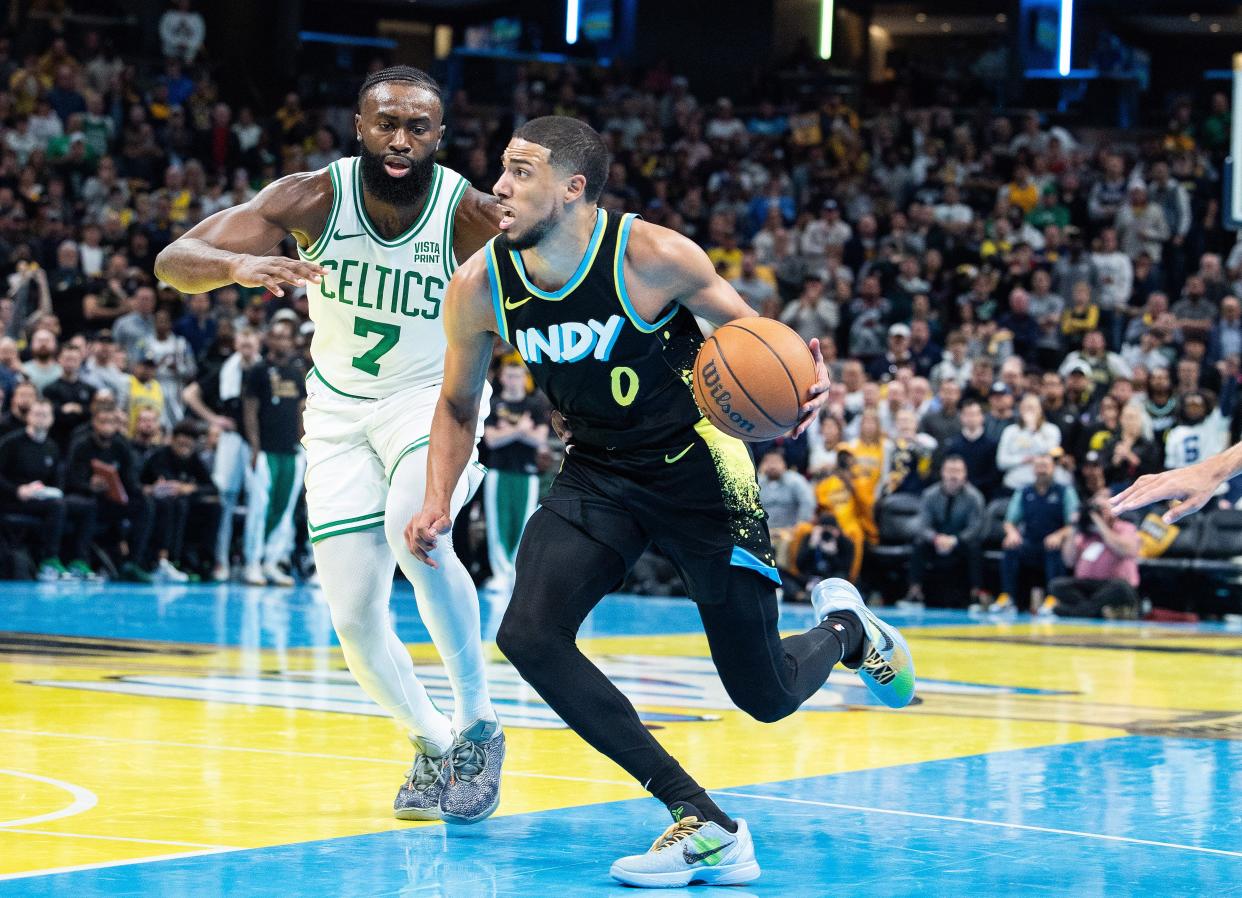 Dec 4, 2023; Indianapolis, Indiana, USA; Indiana Pacers guard Tyrese Haliburton (0) dribbles while Boston Celtics guard Jaylen Brown (7) defends in the second half at Gainbridge Fieldhouse. Mandatory Credit: Trevor Ruszkowski-USA TODAY Sports