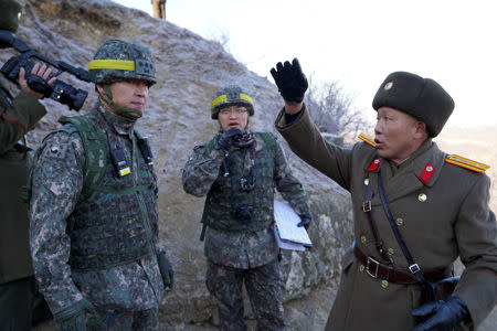 Soldiers from North and South Korea verify the removal of guard posts on each side of the Demilitarized Zone, December 12, 2018. South Korean Defence Ministry/Handout via REUTERS