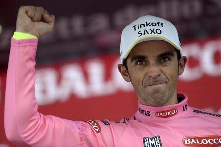 Tinkoff-Saxo rider Alberto Contador of Spain celebrates on the podium as he wears the leader's pink jersey after the 174 Km (108 miles) 16th stage of the 98th Giro d'Italia (Tour of Italy) cycling race from Pinzolo to Aprica , Italy, May 26, 2015. REUTERS/LaPresse/Fabio Ferrari