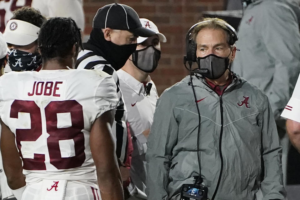 A masked Alabama coach Nick Saban speaks with defensive back Josh Jobe (28) during the second half of the team's NCAA college football game against Mississippi in Oxford, Miss., Saturday, Oct. 10, 2020. Alabama won 63-48. (AP Photo/Rogelio V. Solis)