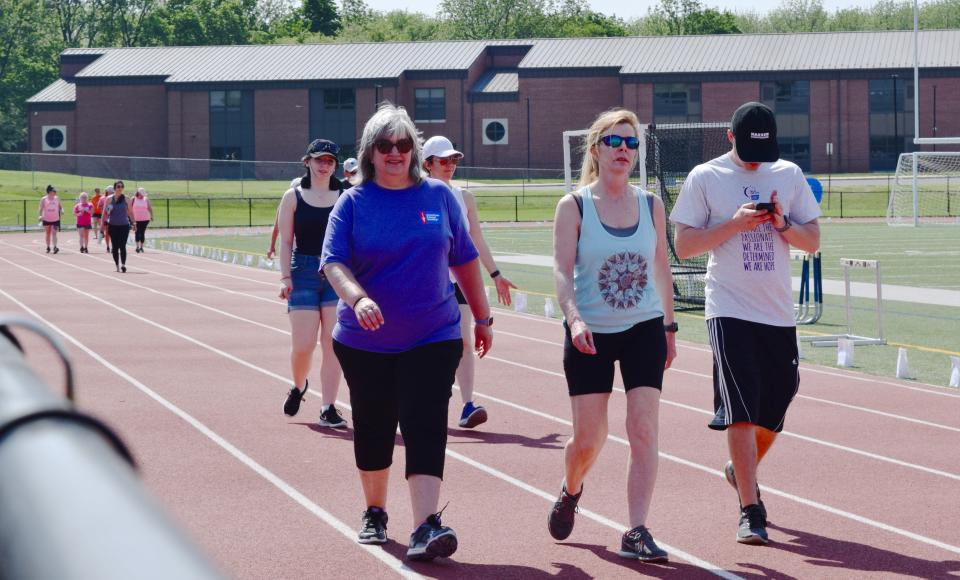 Walkers complete a lap to support the American Cancer Society Saturday at the Relay for Life in Greencastle, Pa.