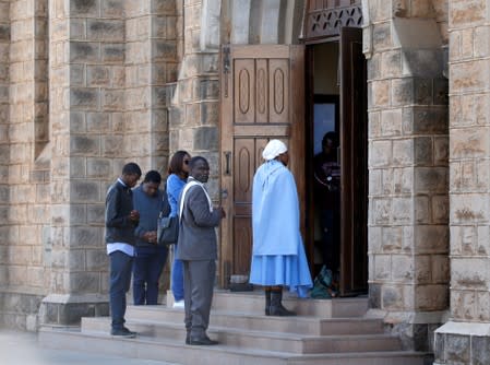 Congregants wait to attend a Catholic mass prayer meeting at a church in Harare