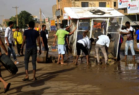 Sudanese protesters erect a barricade on a street and demanding that the country's Transitional Military Council hand over power to civilians in Khartoum