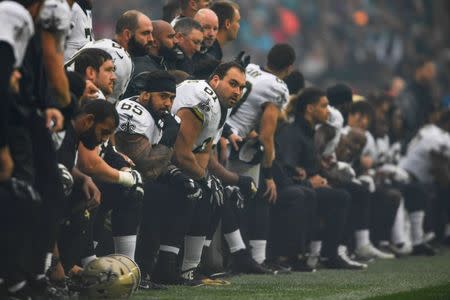 FILE PHOTO: New Orleans Saints players kneel before standing for the American national anthem prior to the game against the Miami Dolphins at Wembley Stadium, London, Middlesex, ENG, Oct 1, 2017. Mandatory Credit: Steve Flynn-USA TODAY Sports