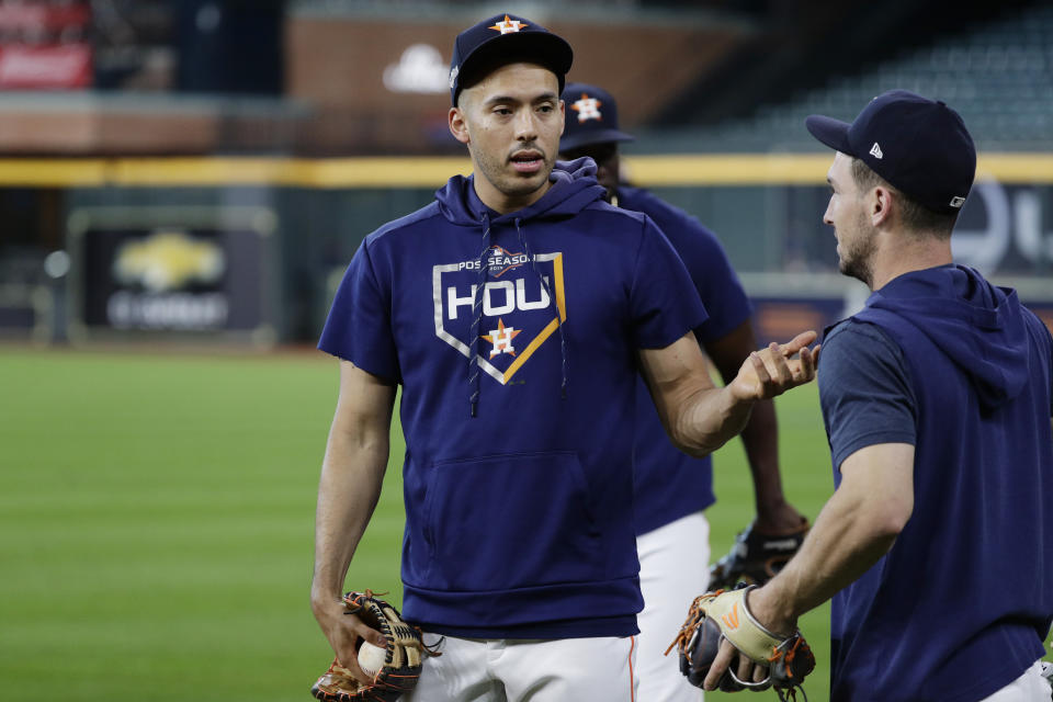 Houston Astros shortstop Carlos Correa, left, talks with teammate Alex Bregman, right, during a workout for a baseball American League Championship Series in Houston, Friday, Oct. 11, 2019. Houston will face the New York Yankees, Saturday. (AP Photo/Eric Gay)