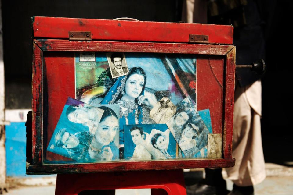 Images decorate Baba Sher's camera. Most are of Hindi movie stars.
