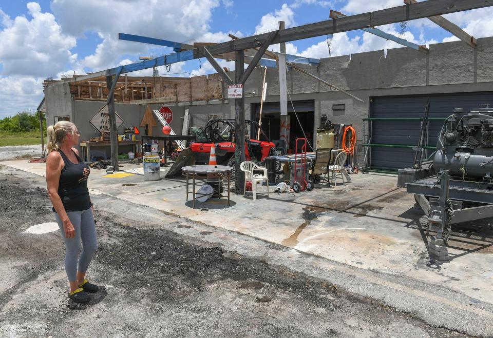 Homeowner Stephanie Goings Trenary looks over Monday's tornado damage that ripped the roof off their barn behind her home in the 14000 block of West Angle Road just outside Fort Pierce on Tuesday, June 7, 2022, in St. Lucie County. "The roof, when it came off, hit the top of our house and flattened our roof in front," Trenary said. "It was done and over within a minute."