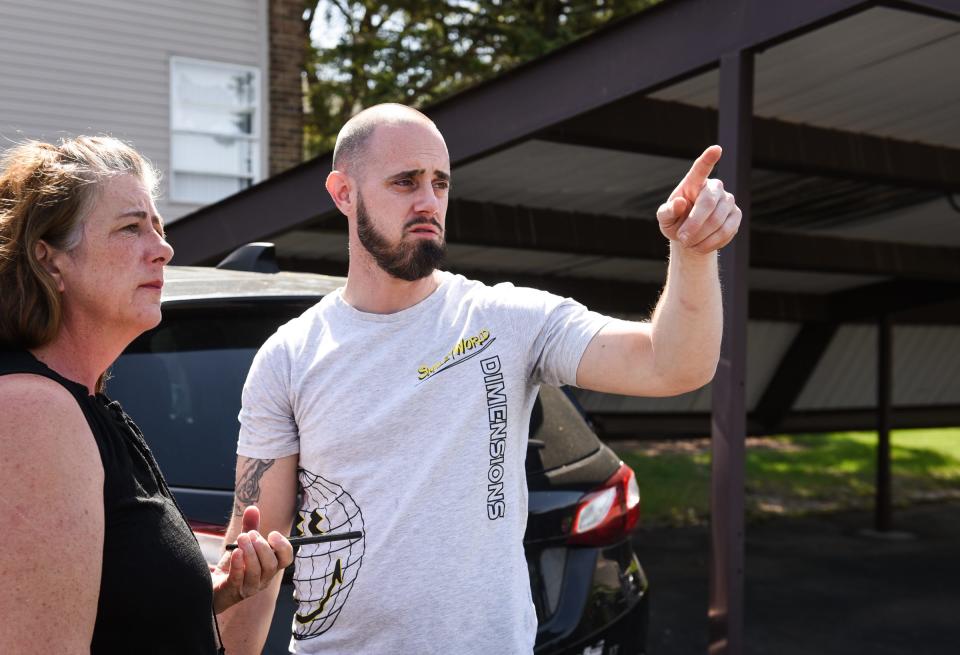 Justin Johnson of Lansing talks with friend Colleen Kelley, Thursday, May 11, 2023, in front of his father's apartment building at Delta Square Apartments in Lansing, before a small search party combed the area searching for his father Richard Johnson, missing since May 7. His father reportedly left an "associate's" apartment at the neighboring Plumtree Apartments and never returned home.