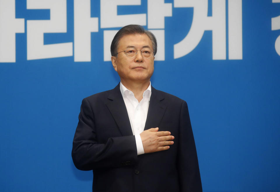 South Korean President Moon Jae-in salutes to a national flag during an emergency cabinet meeting at the presidential Blue House in Seoul, South Korea, Friday, Aug. 2, 2019. Moon has vowed stern countermeasures against Japan's decision to downgrade its trade status, which he described as a deliberate attempt to contain South Korea's economic growth and a "selfish" act that would damage global supply chains.(Bae Jae-man/Yonhap via AP)