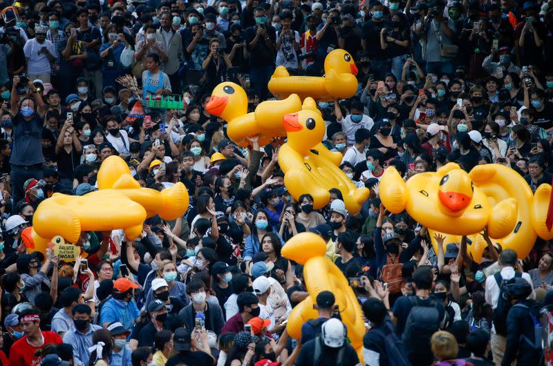 Pro-democracy demonstrators move inflatable rubber ducks during a rally in Bangkok