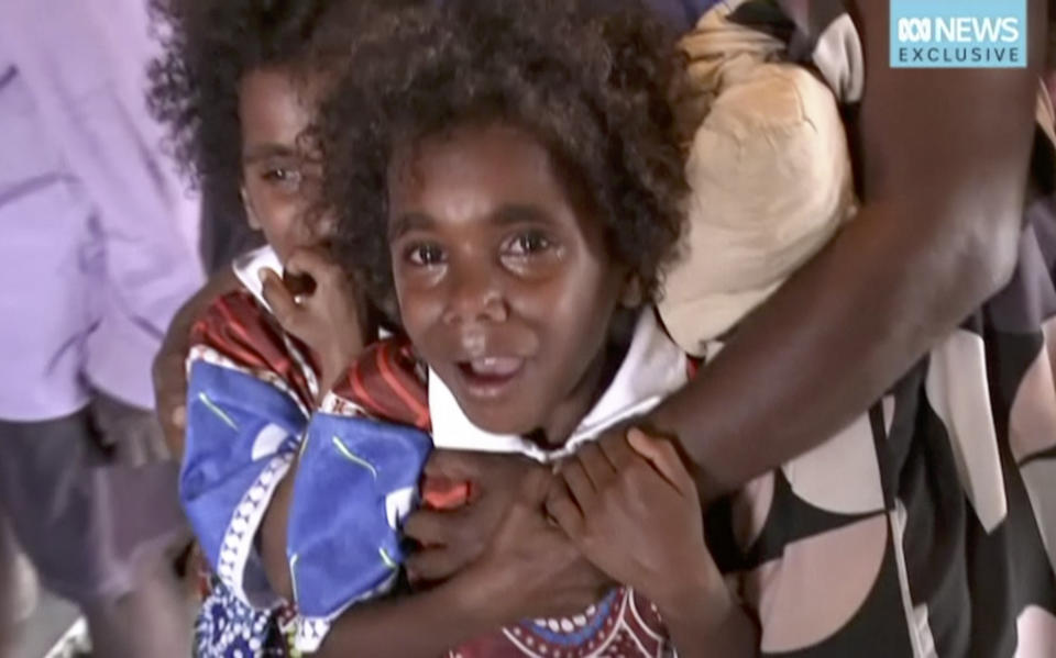 In this image made from video taken on March 21, 2019, storm evacuees board an Australian Defence Force C-130 plane preparing to take off from Borroloola, Australia. Two powerful cyclones are spinning toward Australia's sparsely populated north where around 2,000 people have been evacuated from the east coast of the Northern Territory ahead of strong winds, mountainous waves and flooding rain. (Australian Broadcasting Corporation via AP)