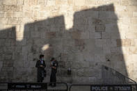 An Israeli police officer speaks with an ultra-Orthodox man during the current nationwide lockdown due to the coronavirus pandemic outside the Jaffa Gate in Jerusalem's old city, Tuesday, Sept. 29, 2020. (AP Photo/Sebastian Scheiner)