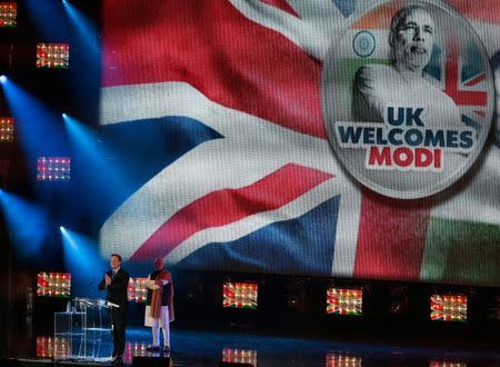 India's Prime Minister Narendra Modi and Britain's Prime Minister David Cameron stand on stage during an event at Wembley Stadium, in London, November 13, 2015. REUTERS/Suzanne Plunkett