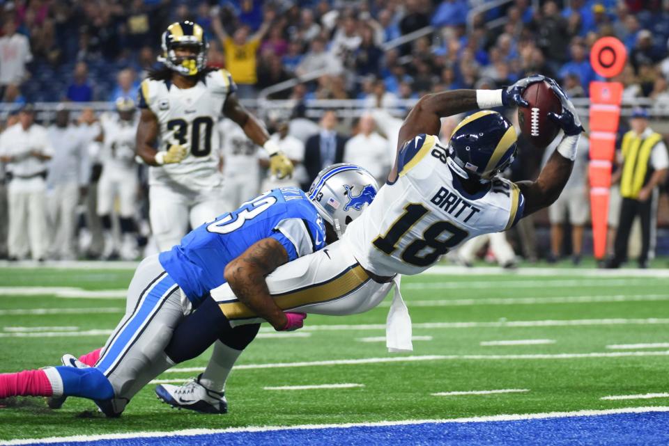 <p>Los Angeles Rams wide receiver Kenny Britt (18) scores a touchdown while being pressured by Detroit Lions cornerback Darius Slay (23)during the first quarter at Ford Field. Mandatory Credit: Tim Fuller-USA TODAY Sports </p>