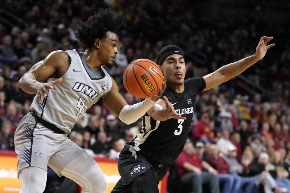 New Hampshire guard Ahmad Robinson (4) fights for a loose ball with Iowa State guard Tamin Lipsey (3) during the second half of an NCAA college basketball game, Sunday, Dec. 31, 2023, in Ames, Iowa. (AP Photo/Charlie Neibergall)