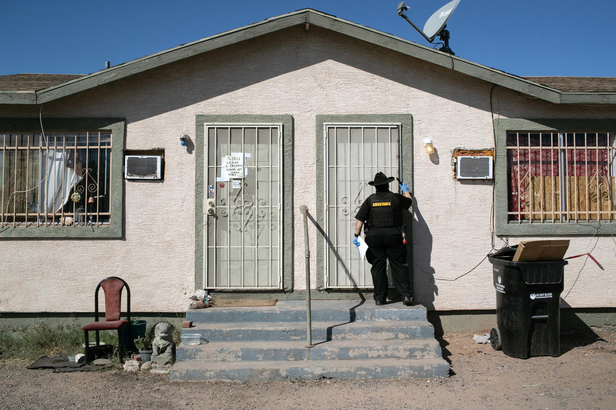 Maricopa County constable Darlene Martinez knocks on a door before posting an eviction order on October 1, 2020 in Phoenix, Az.
