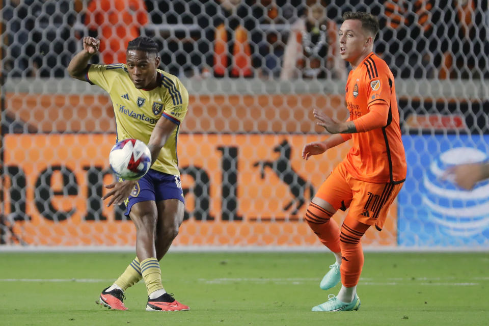 Real Salt Lake midfielder Nelson Palacio, left, kicks the ball away in front of Houston Dynamo forward Corey Baird (11) during the first half of an MLS playoff soccer match Saturday, Nov. 11, 2023, in Houston. (AP Photo/Michael Wyke)