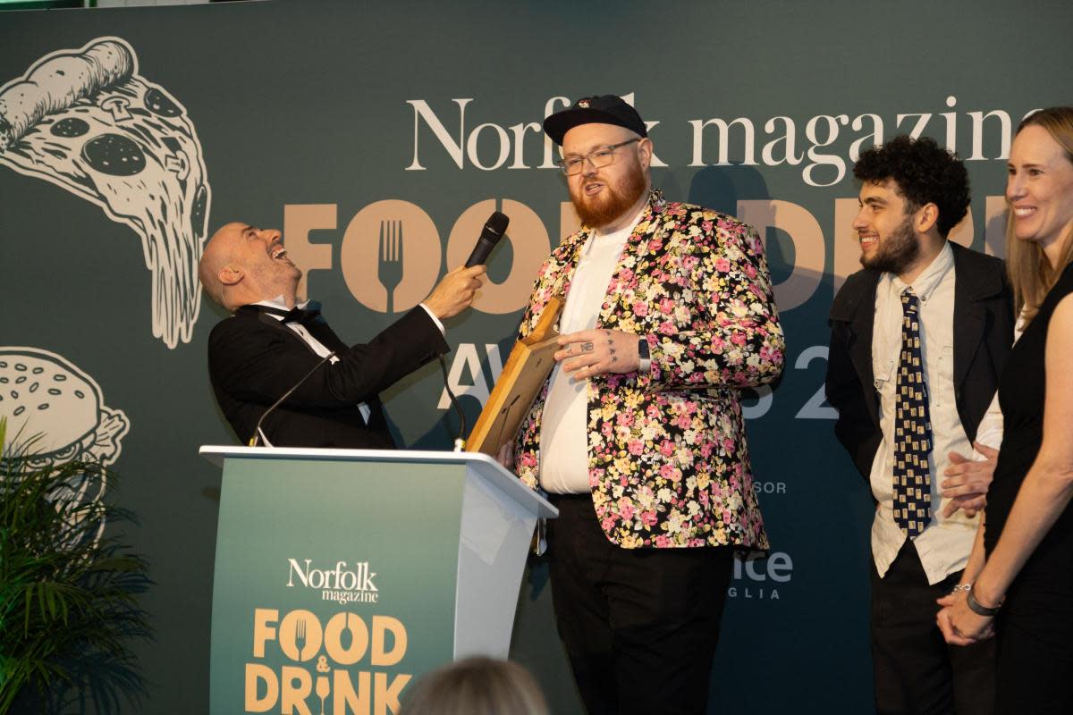 left to right, last year’s host Karl Minns on stage with Edd Watkinson and Jude Porter from The Bodega, which won Best Newcomer, and Hannah Winter (award sponsor - Bread Source) <i>(Image: Matthew Potter Photographer and Videographer)</i>