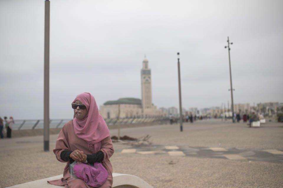 In this Wednesday, July 24, 2019 photo, Fatimazehra Belloucy, 25, a woman affected by a rare disorder called xeroderma pigmentosum, or XP, poses for a portrait by the corniche in Casablanca, Morocco. (AP Photo/Mosa'ab Elshamy)