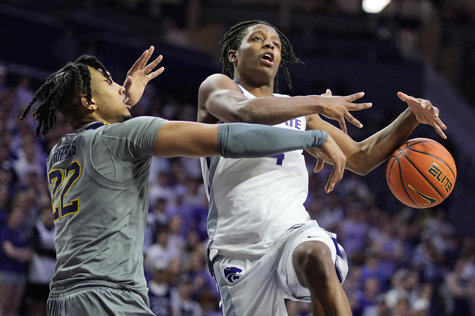 West Virginia forward Josiah Harris (22) knocks the ball away from Kansas State guard Dai Dai Ames during the second half of an NCAA college basketball game Monday, Feb. 26, 2024, in Manhattan, Kan. (AP Photo/Charlie Riedel)