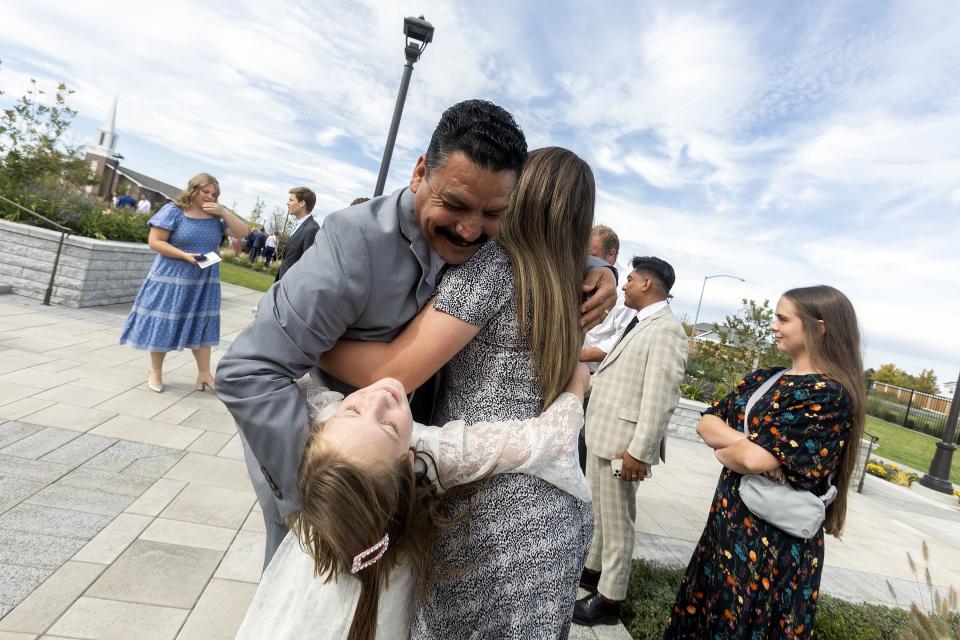 Rodrigo Ceja hugs his family after the dedication of the Moses Lake Washington Temple on Sunday, Sept. 17, 2023.