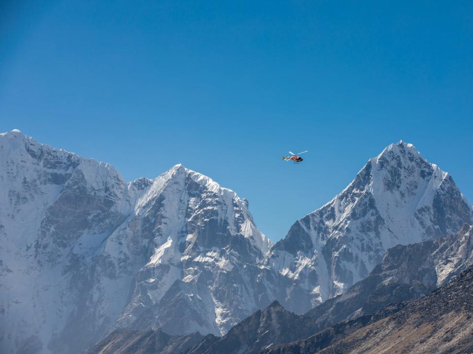 A helicopter circling over Mount Everest.