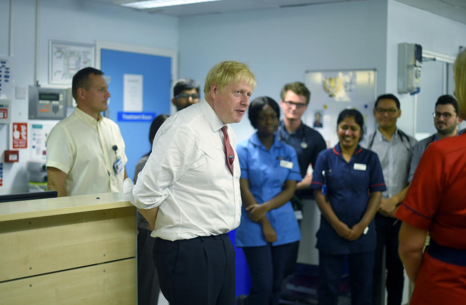 Britain's Prime Minister Boris Johnson speaks to health professionals as he visits Watford General hospital, England, Monday Oct. 7, 2019. The UK government has pledged billions for new hospital projects across England under plans devised up by Health Secretary Matt Hancock. (Peter Summers/Pool via AP)