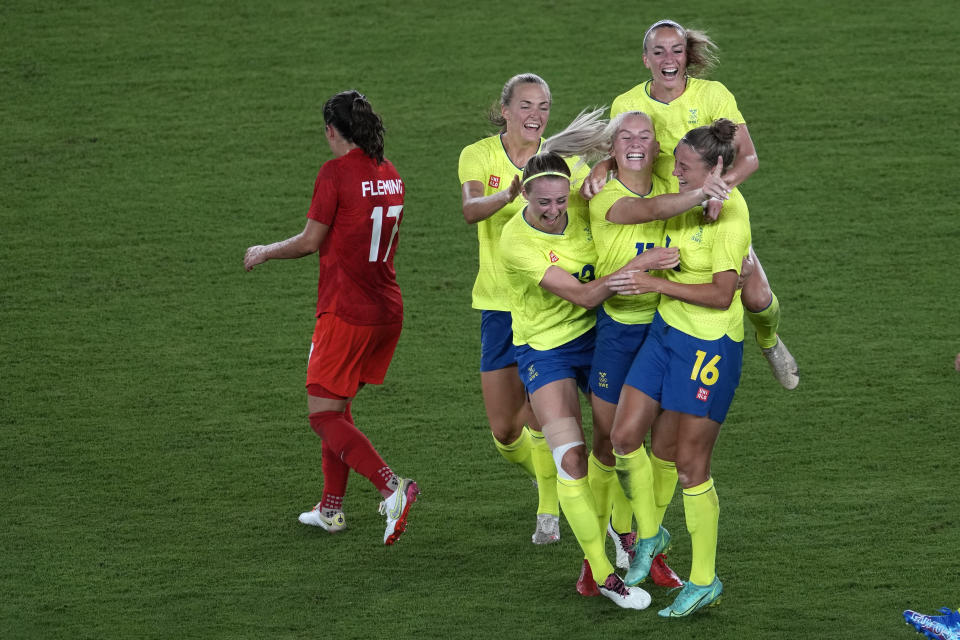 Sweden's Stina Blackstenius, center, celebrates scoring the opening goal against Canada with teammates during the women's final soccer match at the 2020 Summer Olympics, Friday, Aug. 6, 2021, in Yokohama, Japan. (AP Photo/Kiichiro Sato)