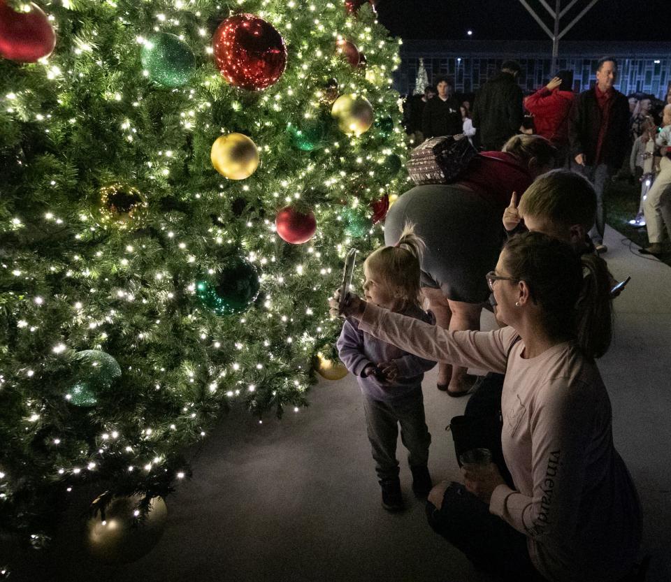 The city of Cape Coral hosted its 3rd Annual Holiday Tree and Menorah Lighting ceremony on the lawn at City Hall on Thursday, Nov. 30, 2023. The Christmas tree, installed by city employees, was 50 feet tall and included colorful ornaments. 
The family-friendly event included a musical performance by student choirs from both Oasis Elementary North and South. A visit from Santa Claus also gave visitors an opportunity to have pictures taken with him.