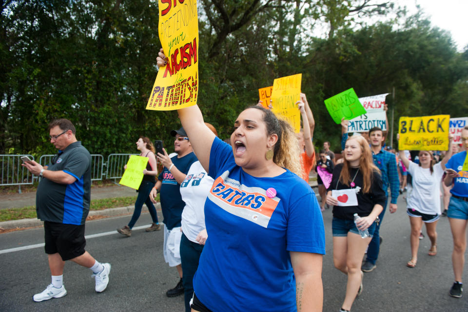 People march down 34th street to the entrance of the University of Florida.&nbsp;