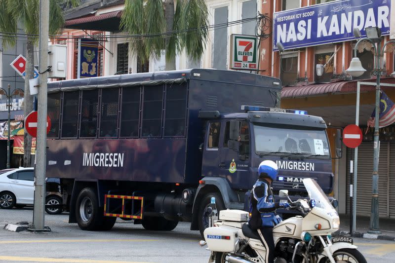 An immigration truck carrying Myanmar migrants to be deported from Malaysia is seen in Lumut