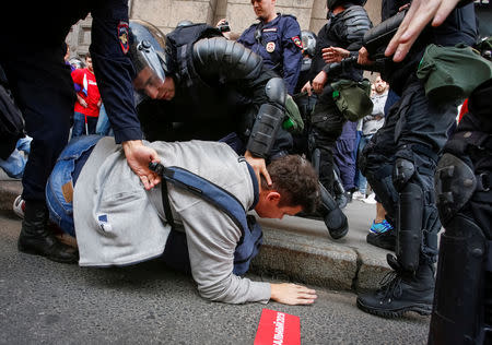 Police officers detain a protester during a rally against planned increases to the nationwide pension age in St. Petersburg, Russia September 9, 2018. REUTERS/Anton Vaganov