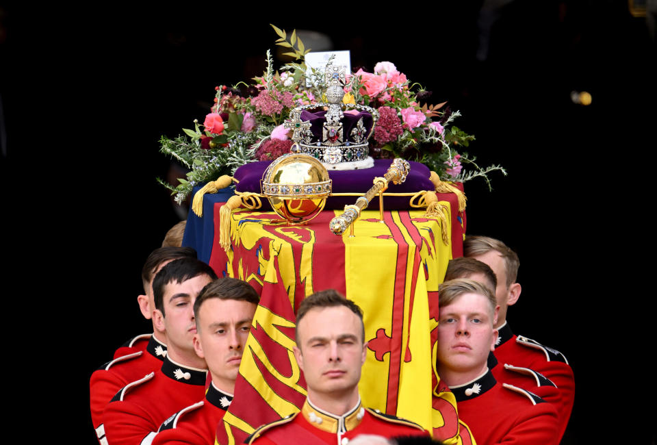 LONDON, ENGLAND - SEPTEMBER 19: HM Queen Elizabeth's coffin is carried out of the doors of Westminster Abbey during The State Funeral Of Queen Elizabeth II at Westminster Abbey on September 19, 2022 in London, England. Elizabeth Alexandra Mary Windsor was born in Bruton Street, Mayfair, London on 21 April 1926. She married Prince Philip in 1947 and ascended the throne of the United Kingdom and Commonwealth on 6 February 1952 after the death of her Father, King George VI. Queen Elizabeth II died at Balmoral Castle in Scotland on September 8, 2022, and is succeeded by her eldest son, King Charles III. (Photo by Karwai Tang/WireImage)