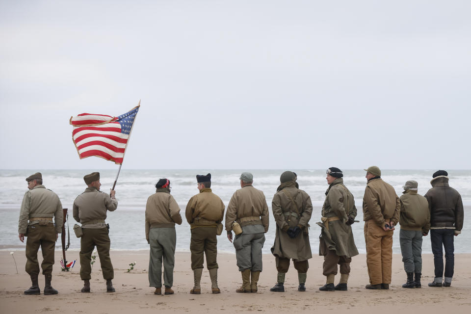 World War II reenactors stand on Omaha Beach in Saint-Laurent-sur-Mer, Normandy, France, Tuesday, June 6, 2023. The D-Day invasion that helped change the course of World War II was unprecedented in scale and audacity. Nearly 160,000 Allied troops landed on the shores of Normandy at dawn on June 6, 1944. (AP Photo/Thomas Padilla)