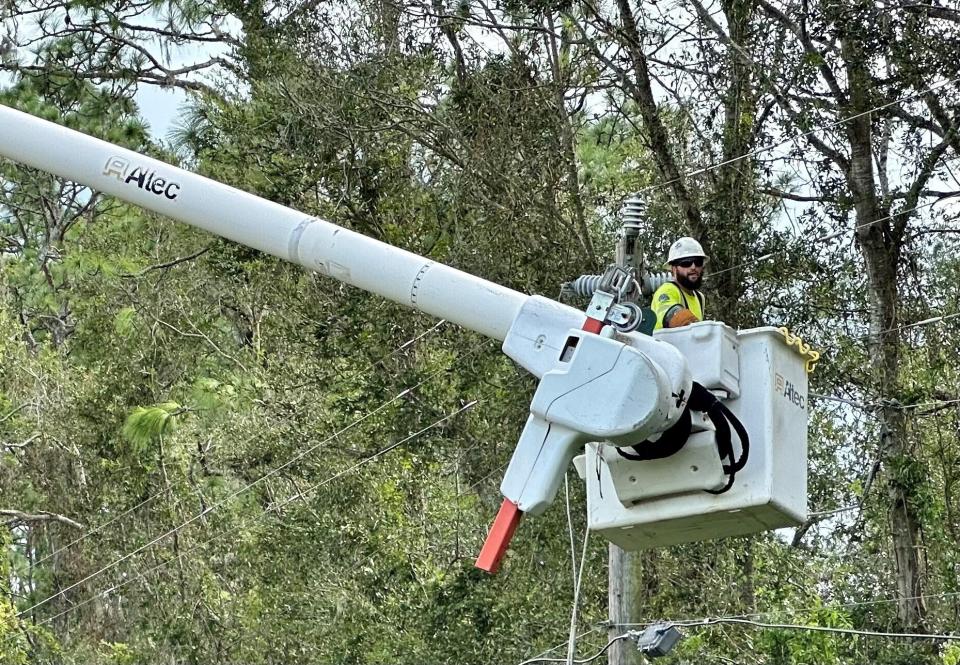 A line worker makes repairs off U.S. Highway 129 in Live Oak on Aug. 31. 2023, a day after Hurricane Idalia made landfall near Keaton Beach, located roughly 78 miles away. The hurricane knocked out power to most residents in Suwannee County