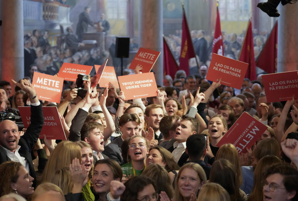 Members of the Social Democratic Party and supporters of Prime Minister Mette Frederiksen celebrate their victory in the parliament in Copenhagen, Tuesday, Nov. 1, 2022. Frederiksen was in a strong position to remain in power after her Social Democrats won the most votes Tuesday in Denmark’s election and a center-left bloc in Parliament that backs her appeared set to retain a majority by just one seat. (AP Photo/Sergei Grits)