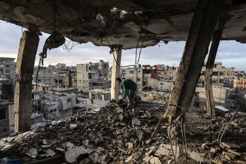 Palestinian inspects his home that was damaged after an Israeli air strike on the Shaboura refugee camp. Abed Rahim Khatib/dpa