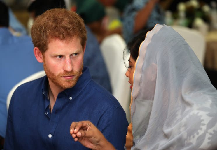 Britain's Prince Harry eats an evening meal to break fast, or the iftar, for Ramadan - the Muslim fasting month, during a visit to a children's home in Singapore, June 4, 2017. REUTERS/Joseph Nair/Pool